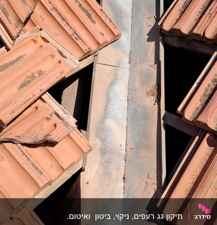 רעפים חומים על גג עם תעלה מתכתית